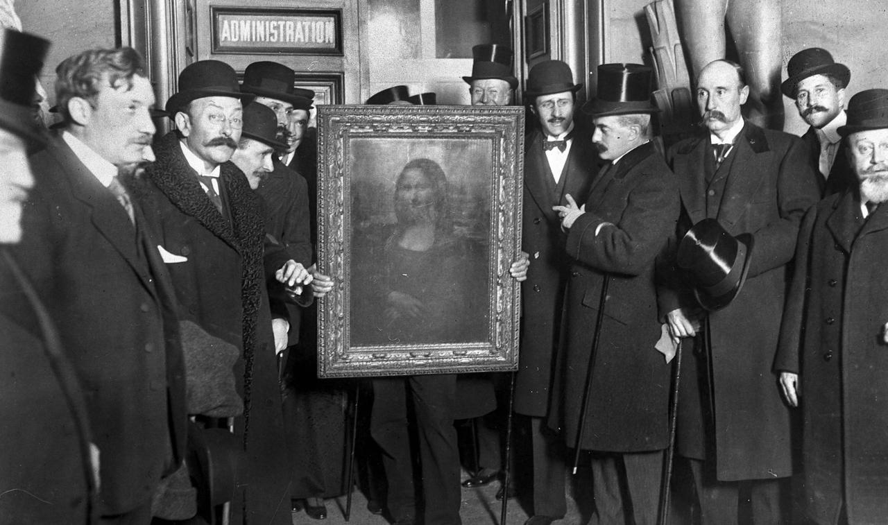 People gather around the Mona Lisa painting on 4 January 1914 in Paris, France, after it was found following its theft in 1911. (Photo via The Guardian)