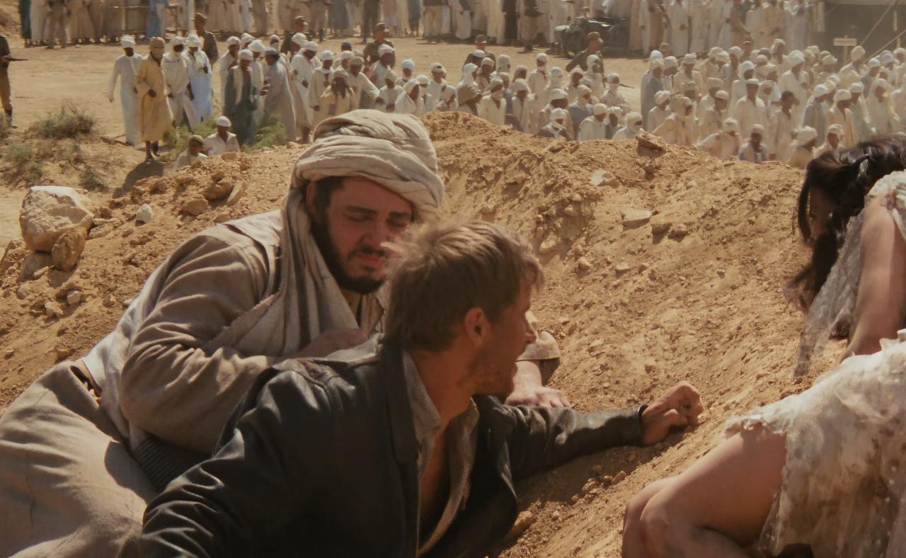 Sallah Mohammed Faisel el-Kahir (John Rhys-Davies, left) and Indiana Jones (Harrison Ford, center) in Indiana Jones and the Raiders of the Lost Ark, 1981. (Photo via