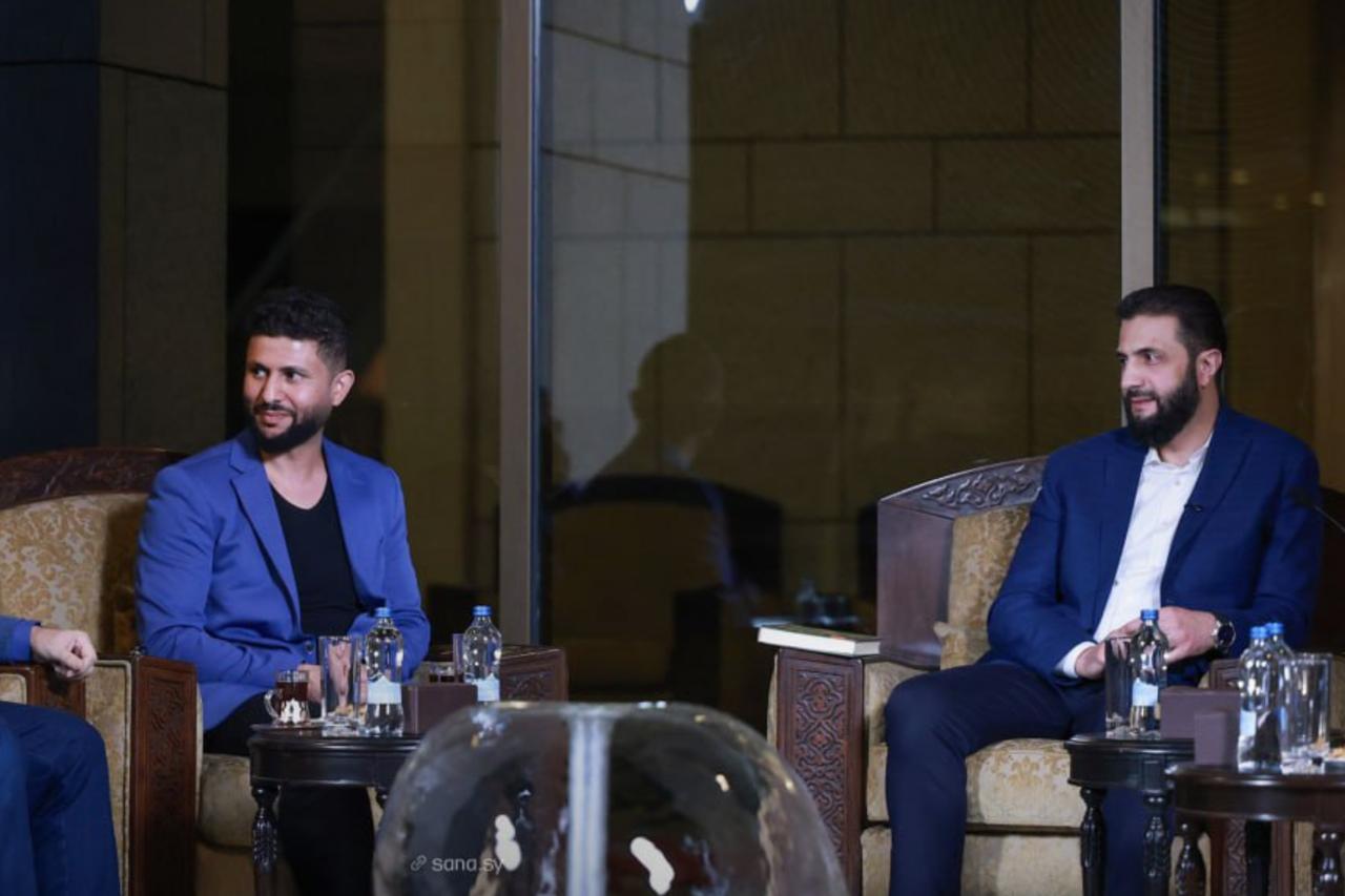 President al-Sharaa meets the Culture Minister and Palestinian poet Jihad al-Turbani with several writers and poets, October 19, 2025. (SANA Photo )