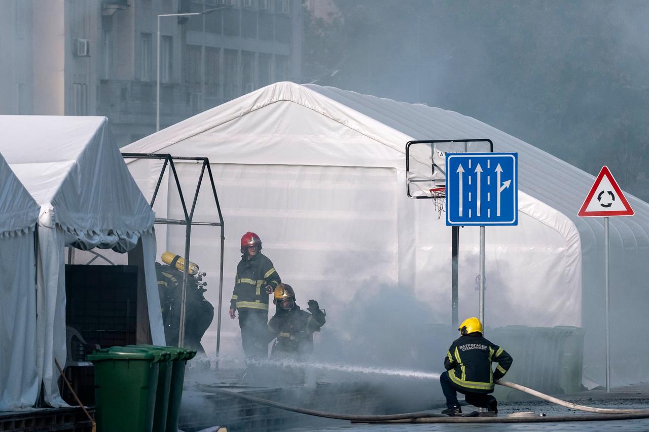 Firefighters work to extinguish a fire in a tent of a pro-government camp outside of Serbia's national parliament, in Belgrade, Serbia on October 22, 2025. (AFP Photo)