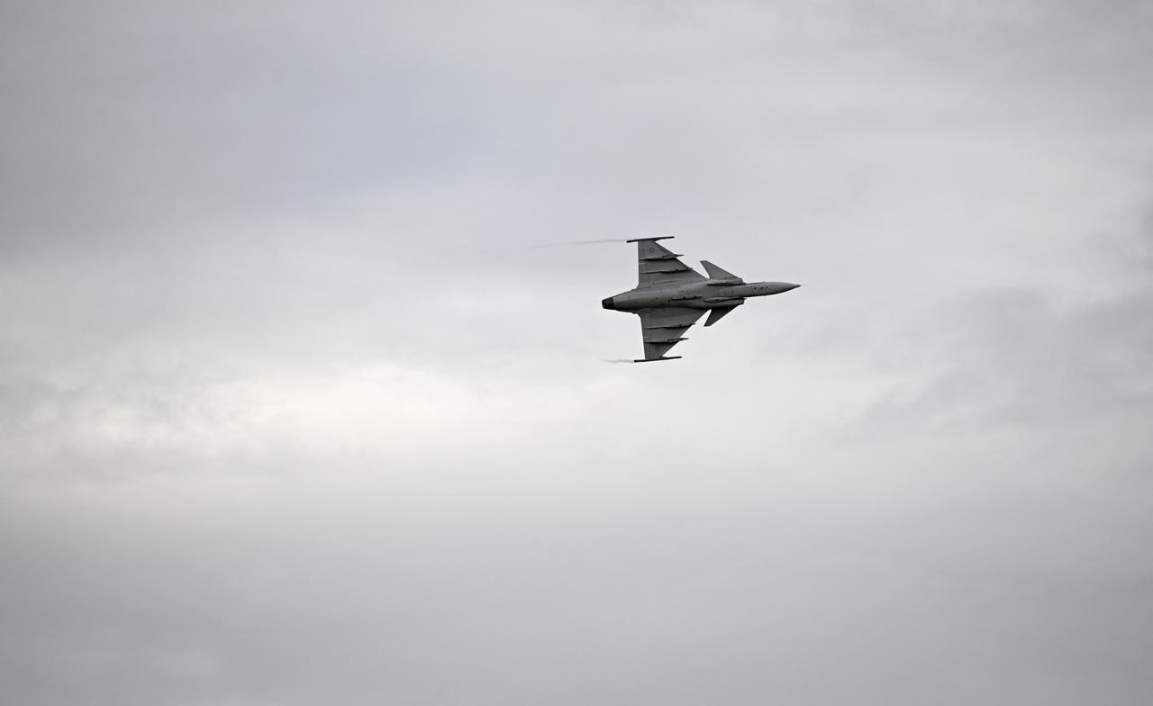 A Saab Gripen E-series fighter aircraft is seen in the sky over the airport of Linkoping, Sweden, as it is shown to the Ukrainian President during his visit Oct. 22, 2025. (AFP Photo)