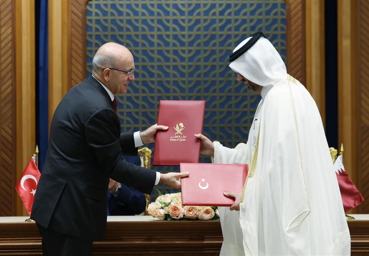 Turkish Treasury and Finance Minister Mehmet Simsek (L) attends a signing ceremony for agreements between Türkiye and Qatar in Doha, Qatar, Oct. 22, 2025. (Photo via Turkish Presidency/Murat Kula)