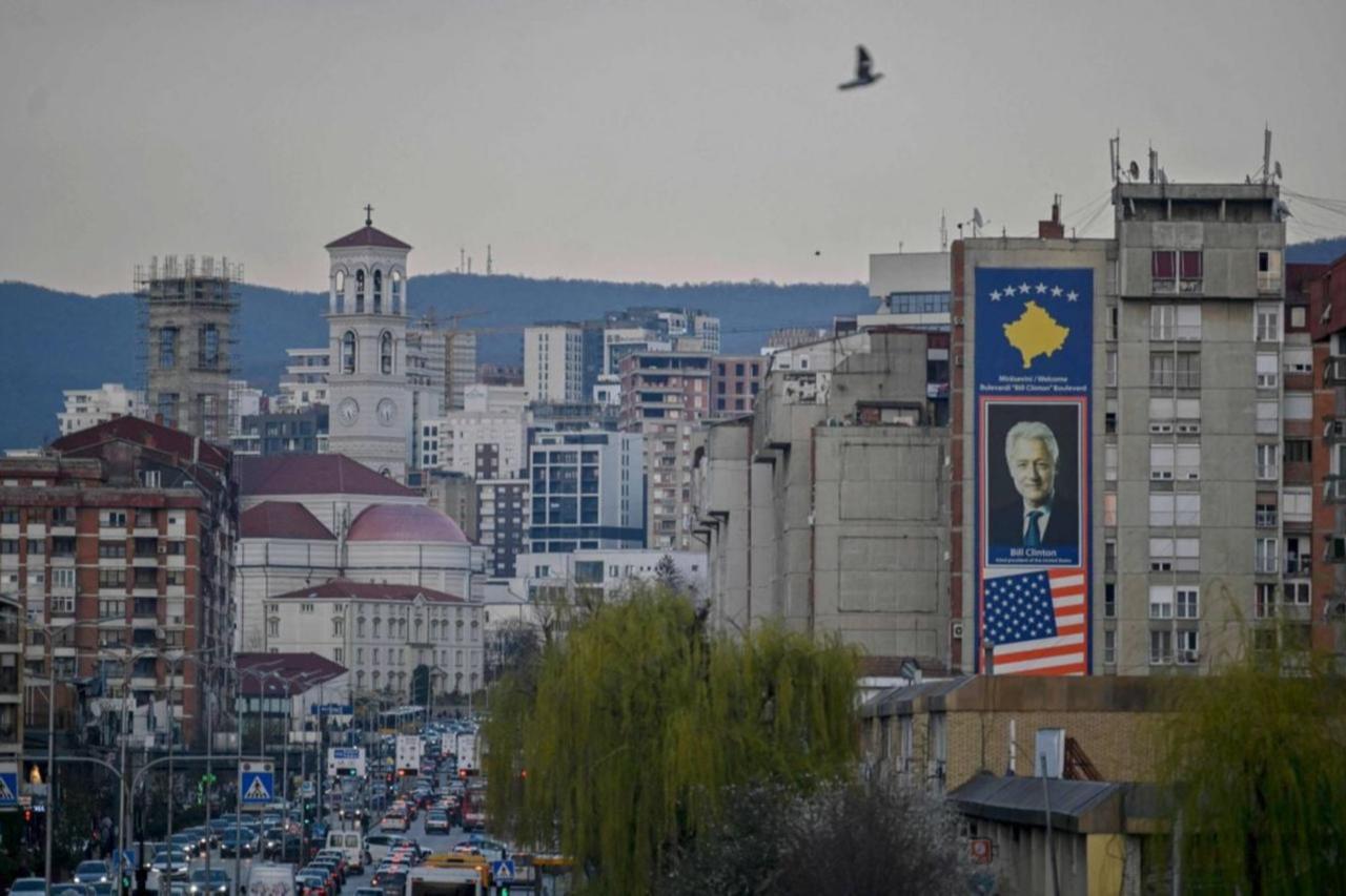 This photo shows a big banner depicting a portrait of former U.S. President Bill Clinton along with United States and Kosovo flags in Pristina, Kosovo, on March 22, 2024. (AFP Photo)