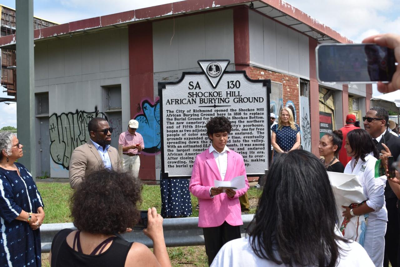 Livi Booker reads the state historic highway marker text at its unveiling on June 12, 2022. (Photo via The Conversation)