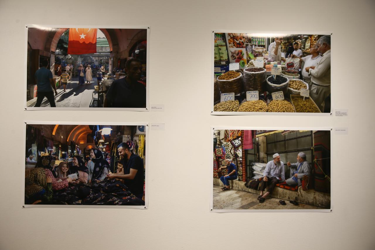 Photographs by Austrian photographer Josef Polleross capture everyday scenes from Sanliurfa’s historic bazaars — from spice sellers to friendly conversations under stone arches — displayed at the “Sanliurfa Tracing a Rich Heritage” exhibition in Vienna, Austria, Oct. 22, 2025. (AA Photo)