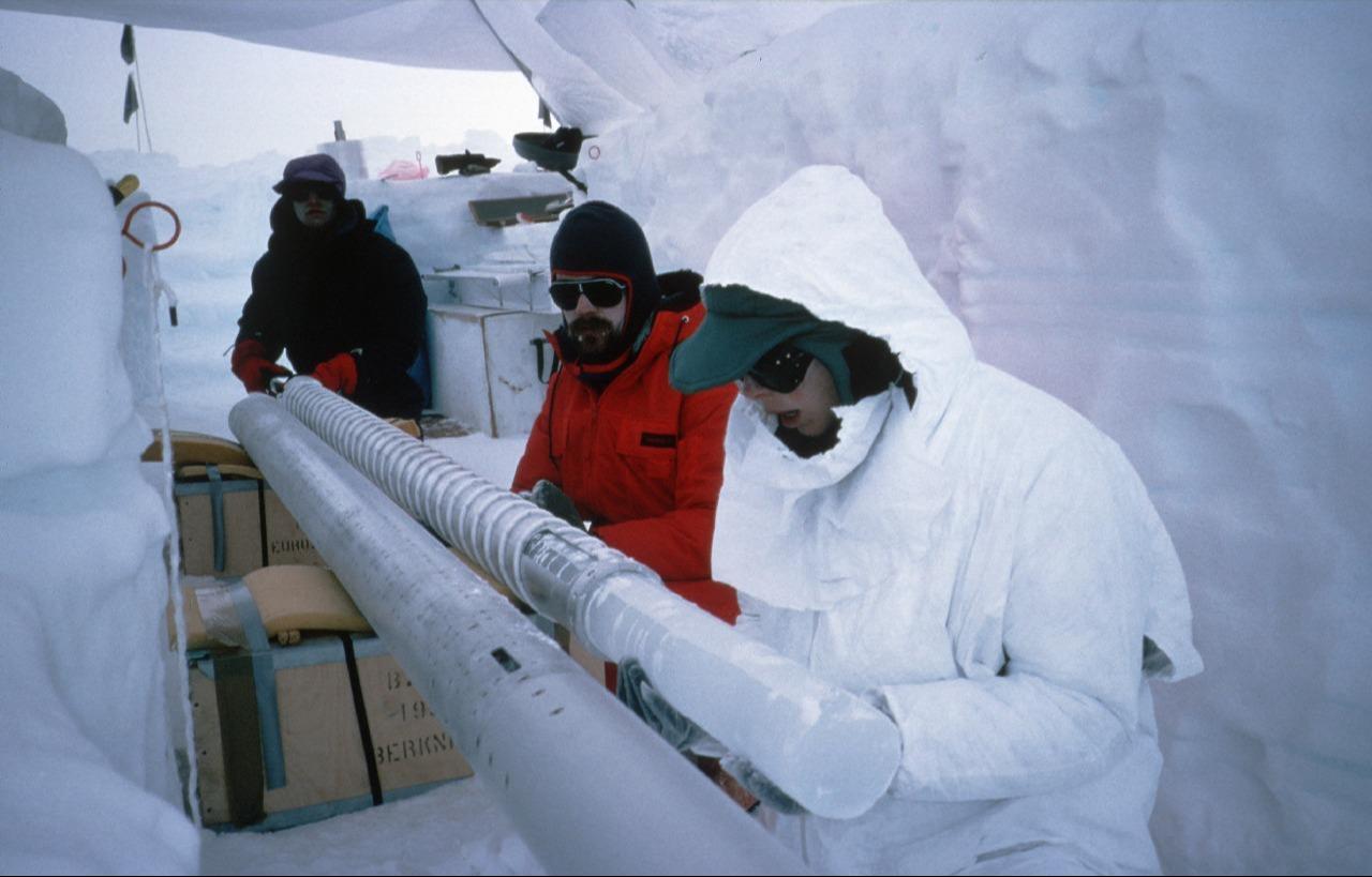 Scientists remove an ice core from a core barrel during drilling in an ice dome on Berkner Island. (Photo via British Antarctic Survey)
