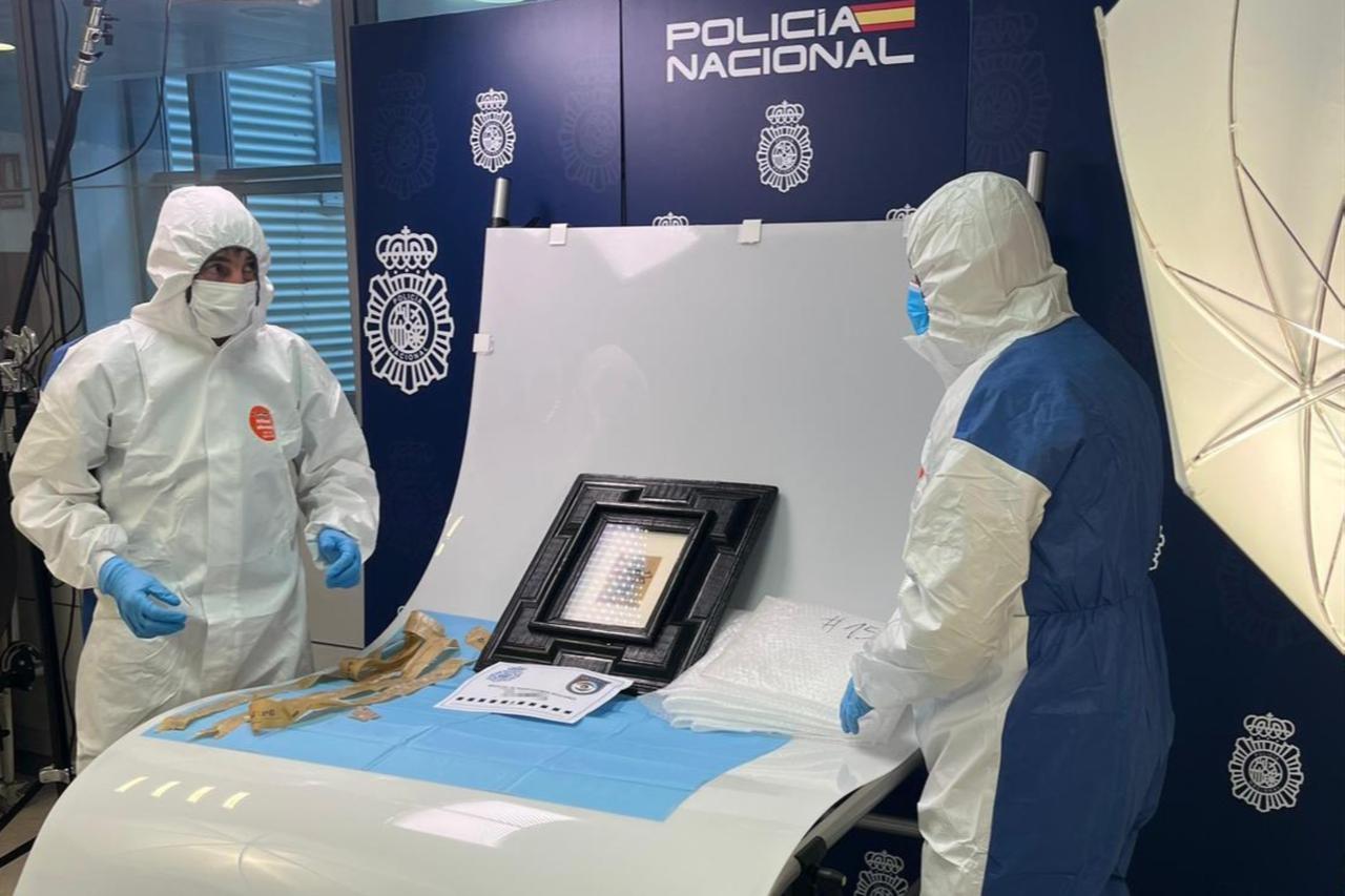 Spanish National Police forensic experts examine Pablo Picasso’s Still Life with a Guitar, recovered after going missing during transport from Madrid to Granada, Oct. 24, 2025. (Photo via Spanish National Police)