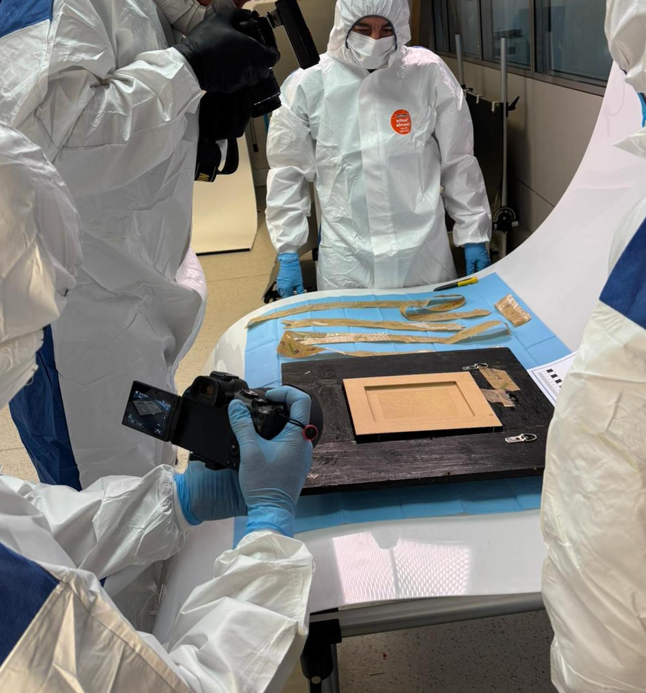 Forensic officers document the back of Pablo Picasso’s Still Life with a Guitar during an inspection at the Spanish National Police laboratory in Madrid, Oct. 24, 2025. (Photo via Spanish National Police)