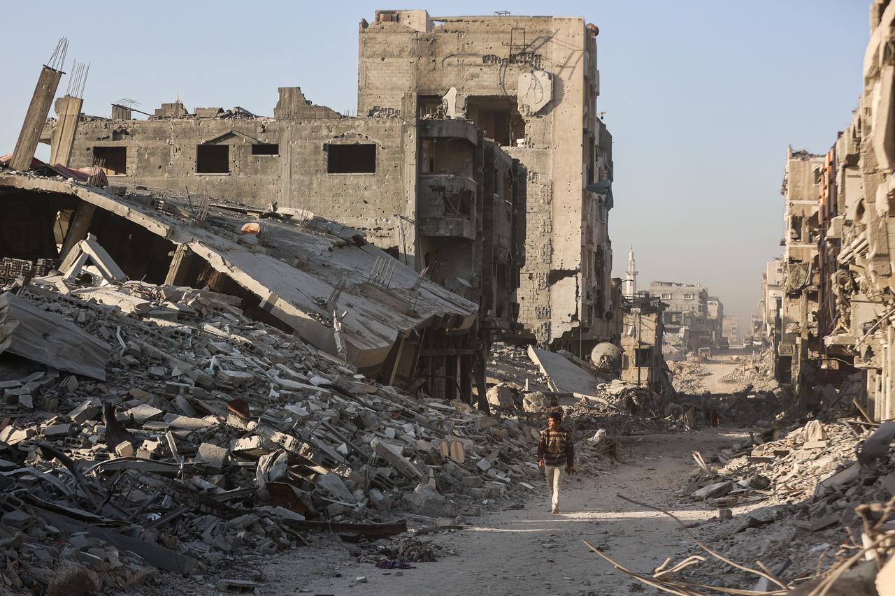 A Palestinian man walks amid the rubble of destroyed buildings in the Sheikh Radwan neighborhood of Gaza City on October 22, 2025. (AFP Photo)