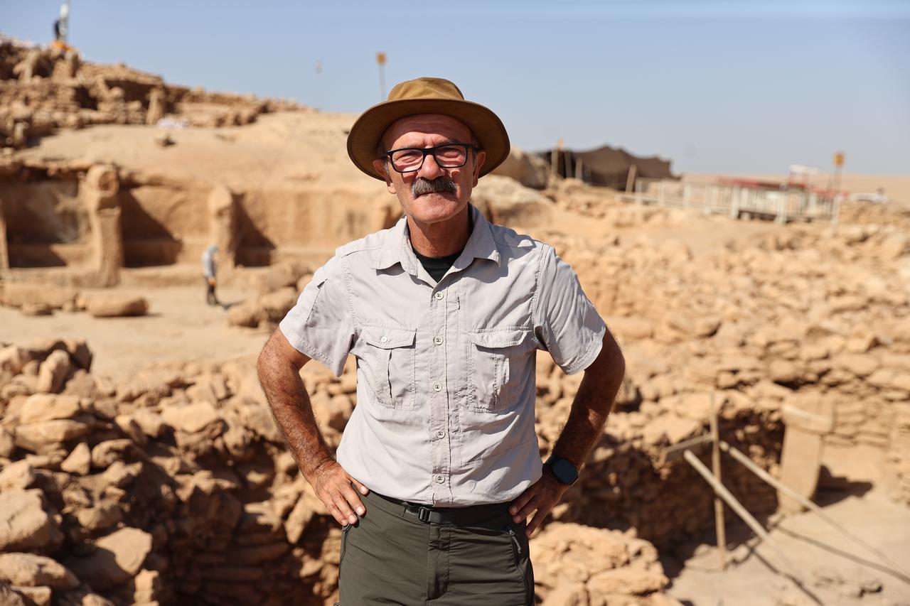Professor Necmi Karul, head of the Karahantepe excavations, stands among the Neolithic structures where stone-built dwellings and public buildings coexist. (AA Photo)