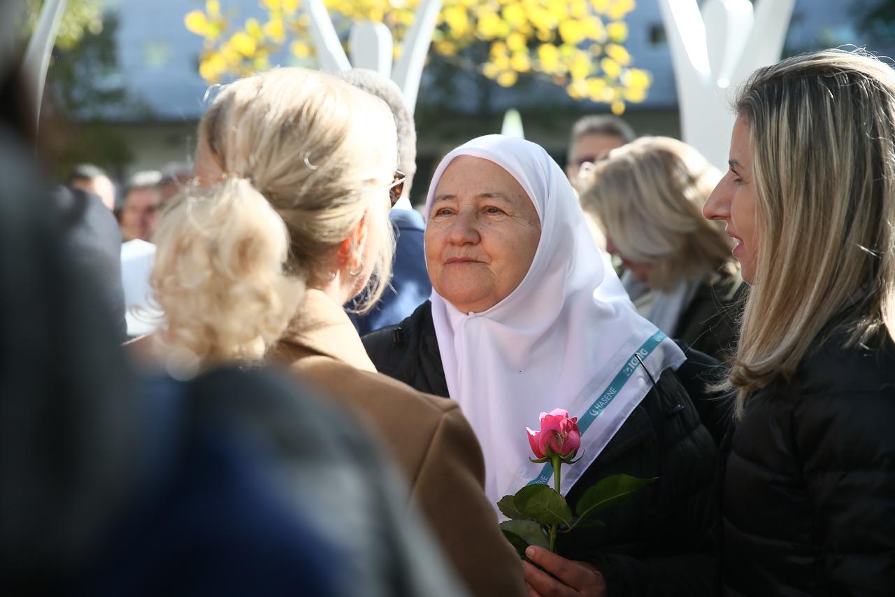 A woman holding a rose “Srebrenica Flower” monument. Vienna, Austria, October 24, 2025. (AA Photo)