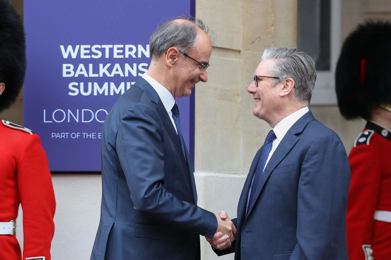 British Prime Minister Keir Starmer (R) greets Serbian Prime Minister Djuro Macut (L) at Lancaster House ahead of the Western Balkans Summit 2025 as part of the Berlin Process, a five-year program focusing on six Balkan countries, in London, United Kingdom on Oct. 22, 2025. (AA Photo)
