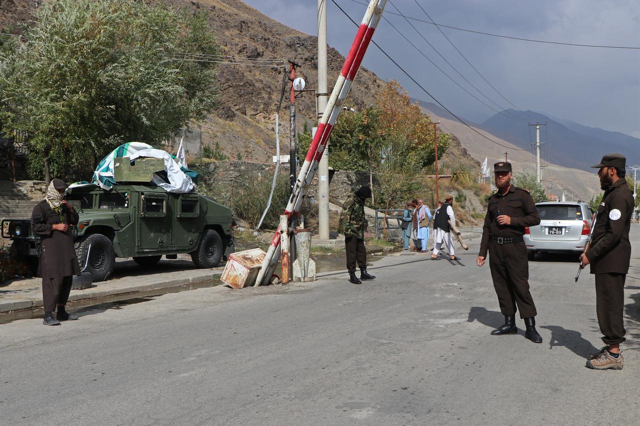 Taliban security personnel stand guard at a checkpoint along a road at the Bazarak in Panjshir Province on October 21, 2025. (AFP Photo)
