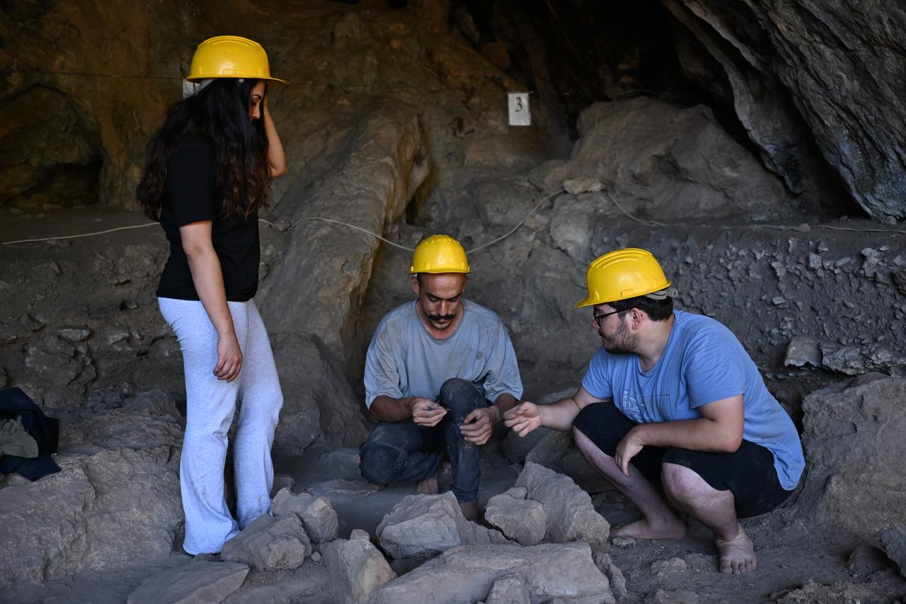 Archaeologists examine finds during ongoing excavations inside Direkli Cave in Kahramanmaras, Türkiye, Oct. 27, 2025. (AA Photo)