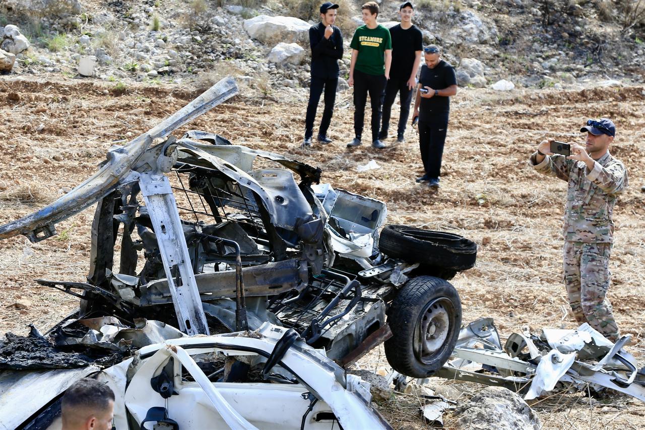 A view of the completely destroyed vehicle following the Israeli army drone strike as security forces arrived at the scene to conduct investigations in the town of Harouf, near Nabatieh, southern Lebanon, Oct. 25, 2025. (AA Photo)