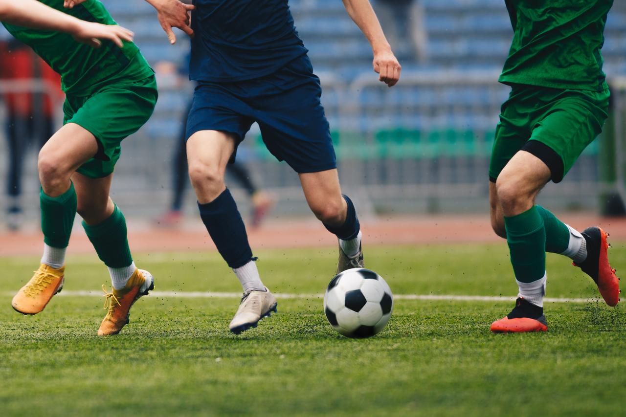 Football players in action during a game. (Adobe Stock Photo)