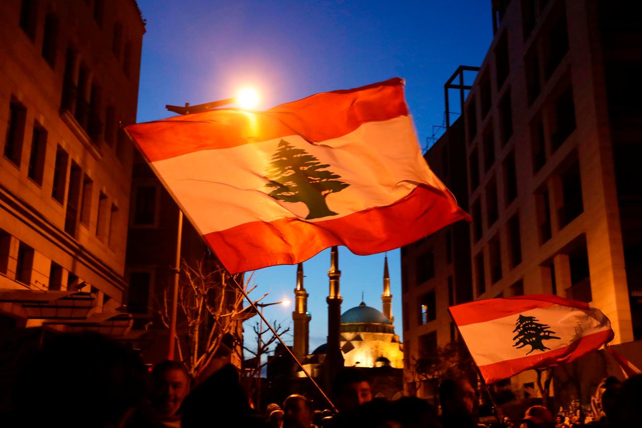 Lebanese demonstrators wave the national flag as they march in downtown Beirut on January 11, 2020. (AFP Photo)