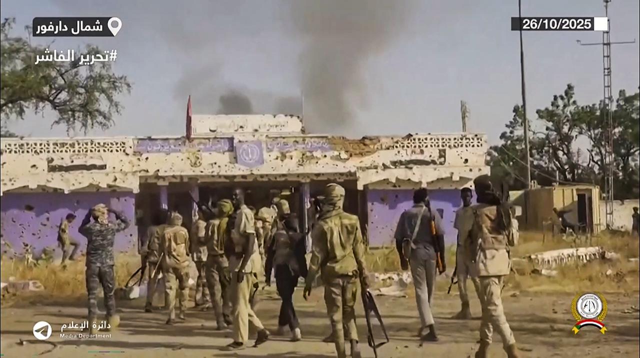 This image grab taken from handout video footage released on Sudan's paramilitary Rapid Support Forces (RSF) Telegram account on October 26, 2025, shows RSF fighters holding weapons and celebrating in the streets of El-Fasher in Sudan's Darfur, on October 27, 2025. (AFP Photo )