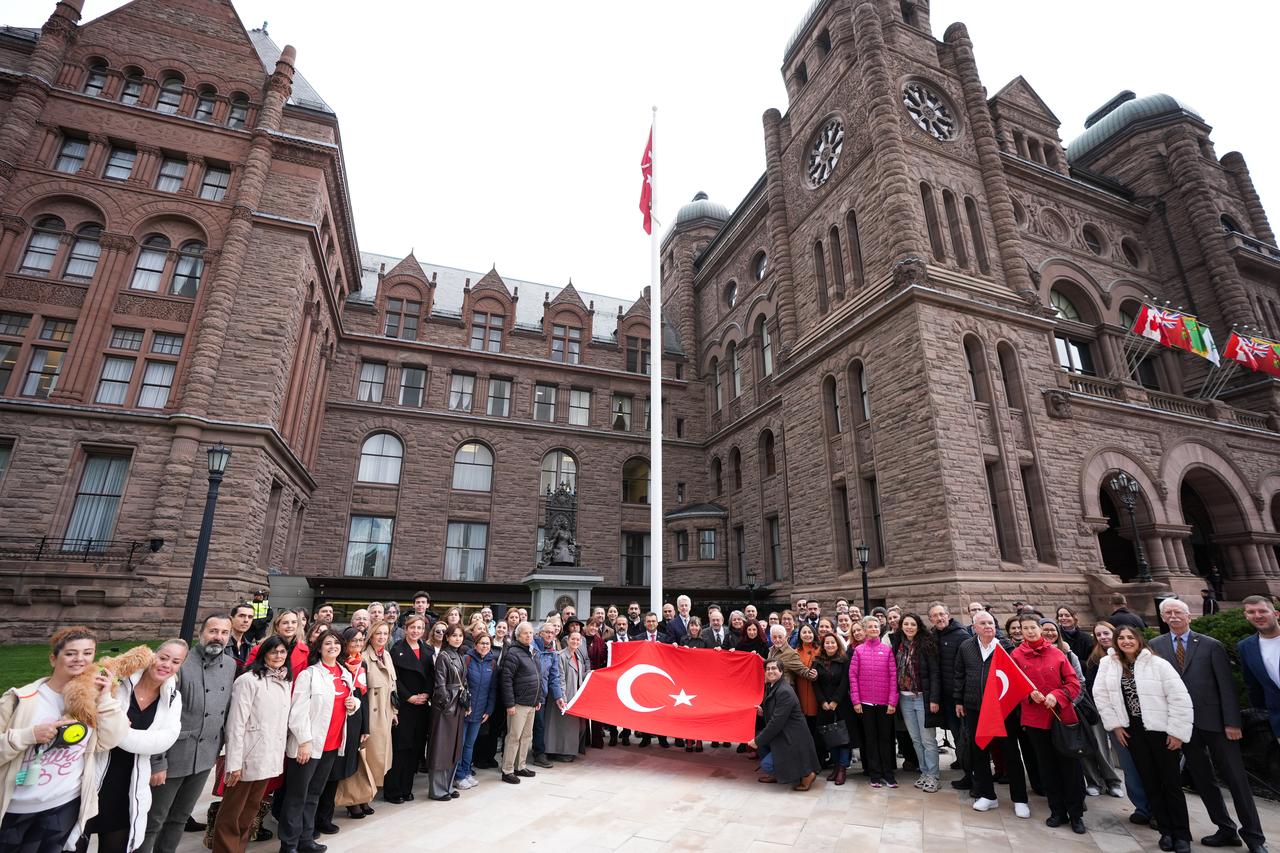 Participants pose after raising the Turkish national flag during a Republic Day ceremony at the Ontario Legislative Building in Toronto, Canada, Oct. 28, 2025. (AA Photo)