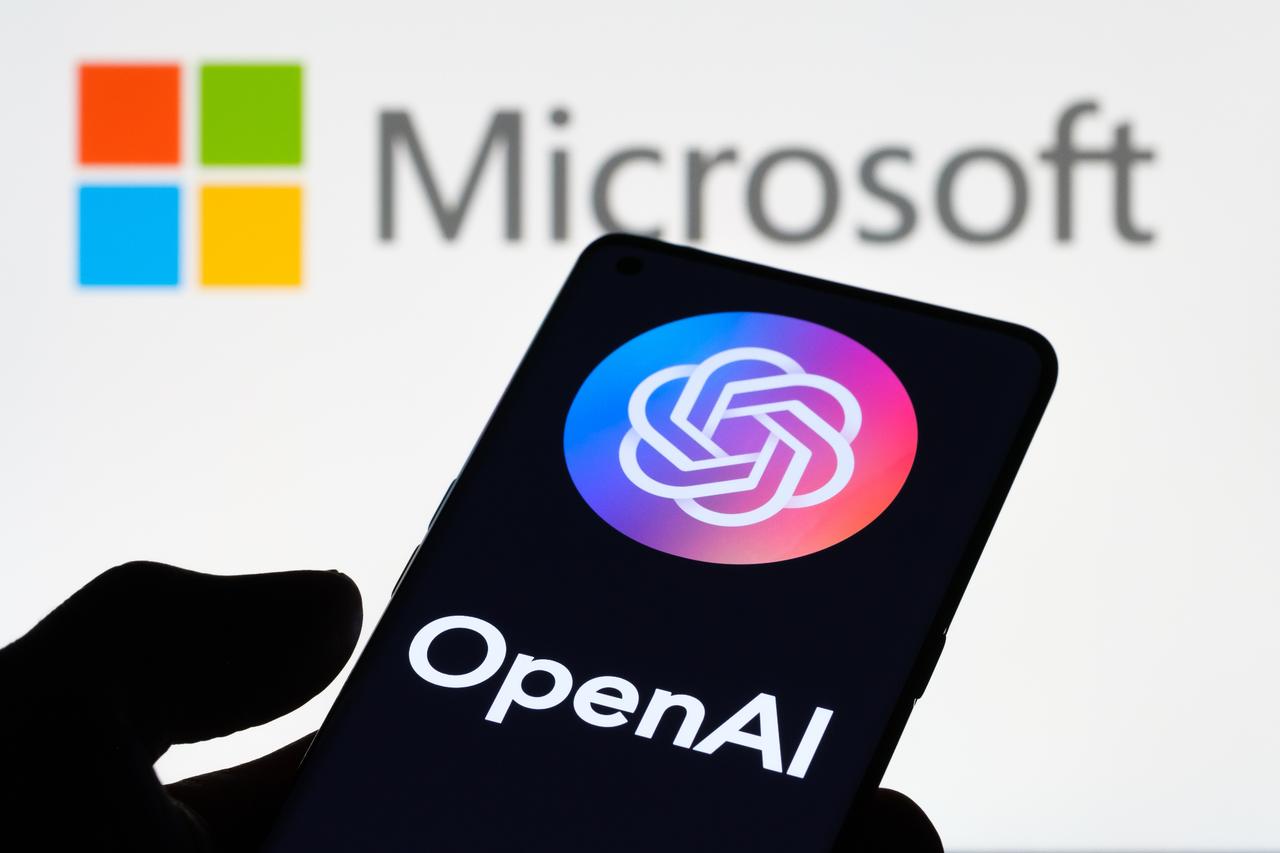 OpenAI logo displayed on a smartphone, with the Microsoft logo in the background. (Adobe Stock Photo)