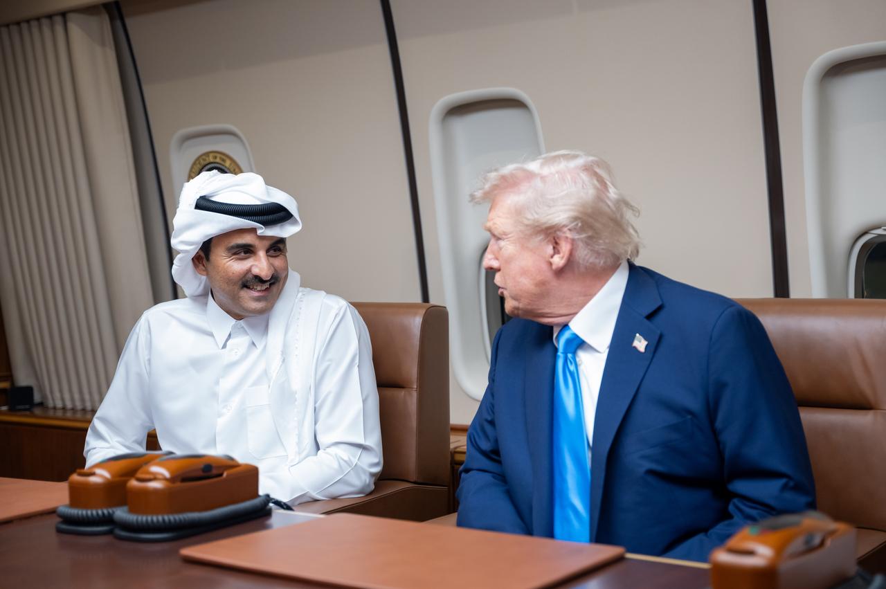 Emir of Qatar Sheikh Tamim bin Hamad Al Thani (L) meets with US President Donald Trump (R) aboard the plane in Doha, Qatar on October 25, 2025. (Photo via Amiri Diwan of the State of Qatar)