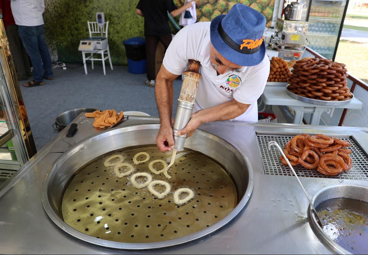 A vendor prepares Adana halka tatlisi (traditional dessert) at the 8th International Taste of Adana Festival in Adana, Türkiye, Oct. 18, 2024. (IHA Photo)