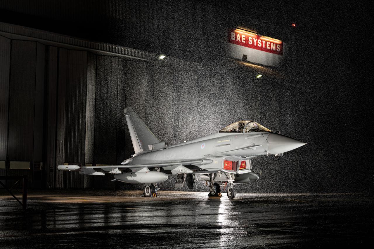 A Eurofighter Typhoon fighter jet with BAE Systems logo can be seen in the background at an unspecified time and location. (Photo via BAE Systems)