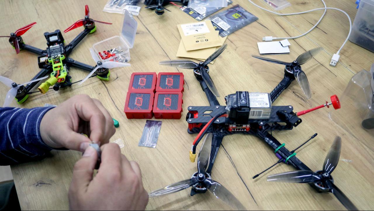 A Ukrainian activist works on a drone in western Lviv, on April 1, 2022. (AFP Photo)
