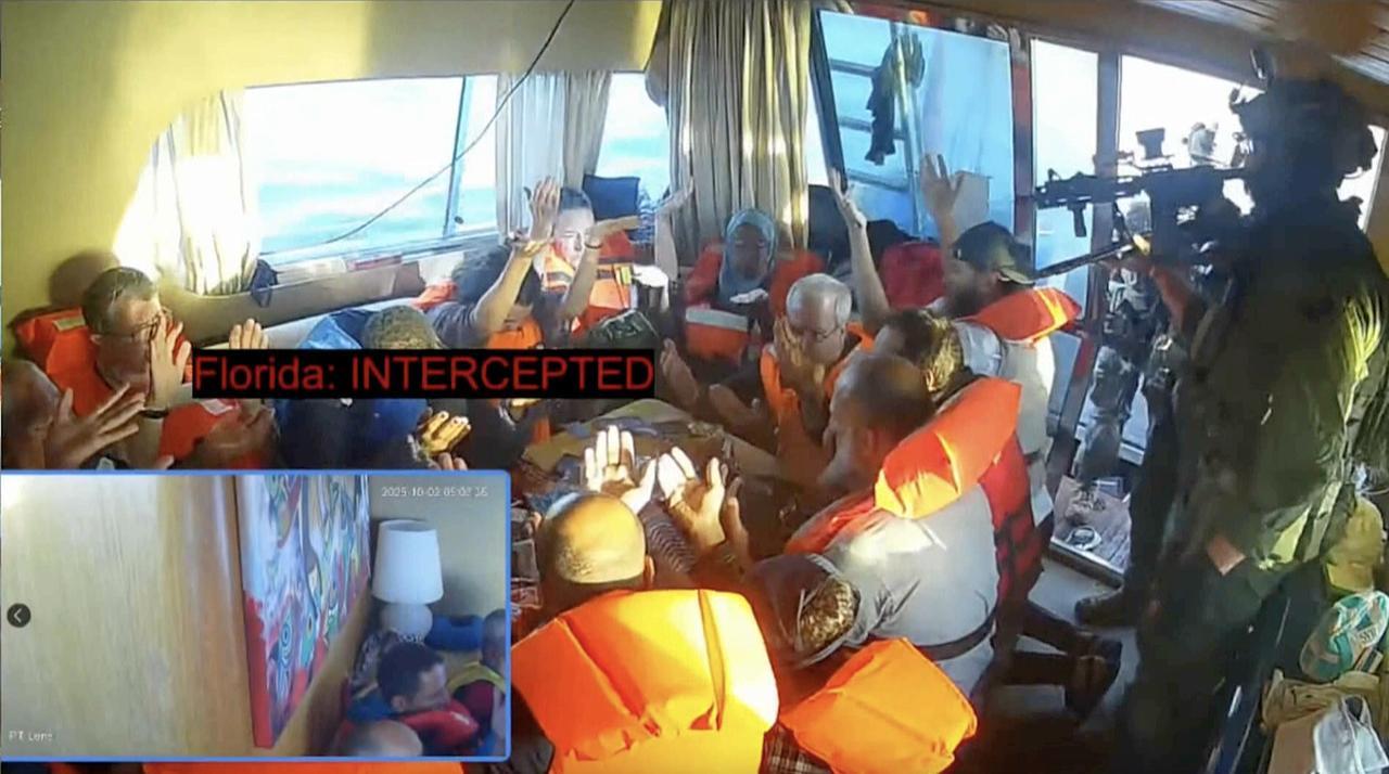 A screen grab shows activists aboard a Global Sumud Flotilla vessel raising their hands to prove they were unarmed in the Mediterranean Sea, Oct. 02, 2025. (Photo via Global Sumud Flotilla)