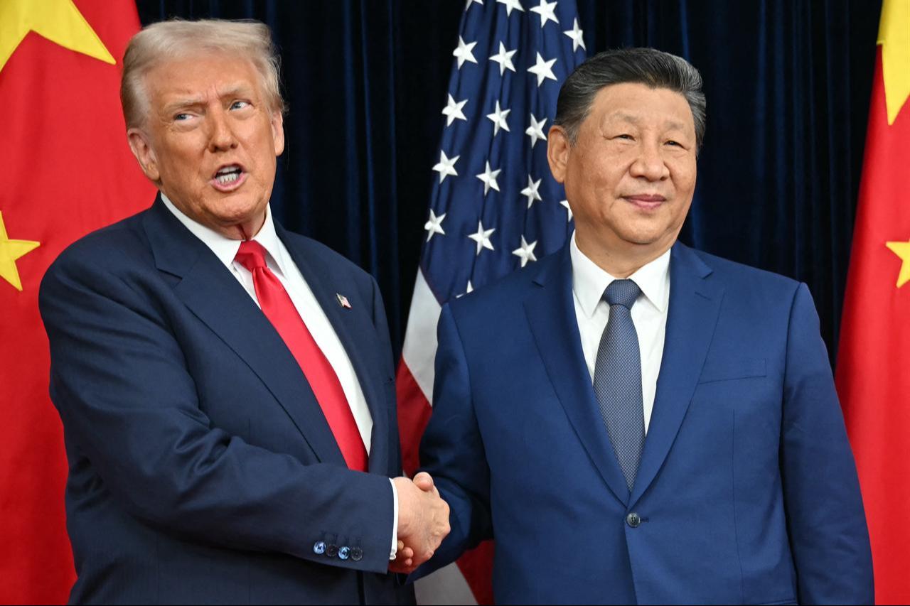 US President Donald Trump (L) and China's President Xi Jinping shake hands as they arrive for talks at the Gimhae Air Base, in Busan on October 30, 2025. (AFP Photo)
