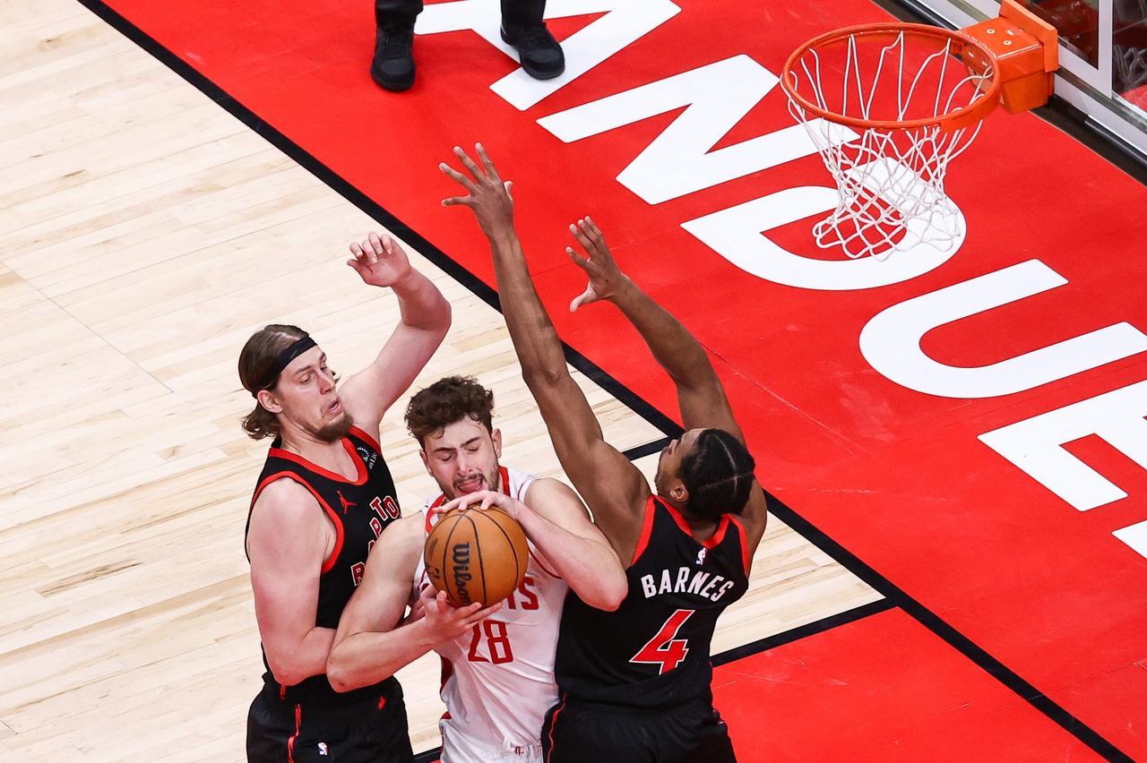 Alperen Sengun (28) of the Houston Rockets in action against Kelly Olynyk (41) and Scottie Barnes (4) of Toronto Raptors during the NBA match between Toronto Raptors and Houston Rockets at Scotiabank Arena in Toronto, Ontario, Canada on December 22, 2024. (AA Photo)
