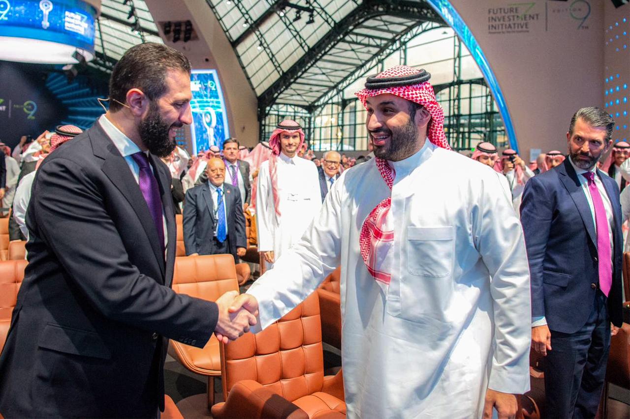 This handout picture provided by the Saudi Press Agency (SPA) shows Syria's interim President Ahmed al-Sharaa  being welcomed by Saudi Crown Prince Mohammed bin Salman, during the Future Investment Initiative (FII) conference in Riyadh on October 29, 2025. ( AFP Photo )