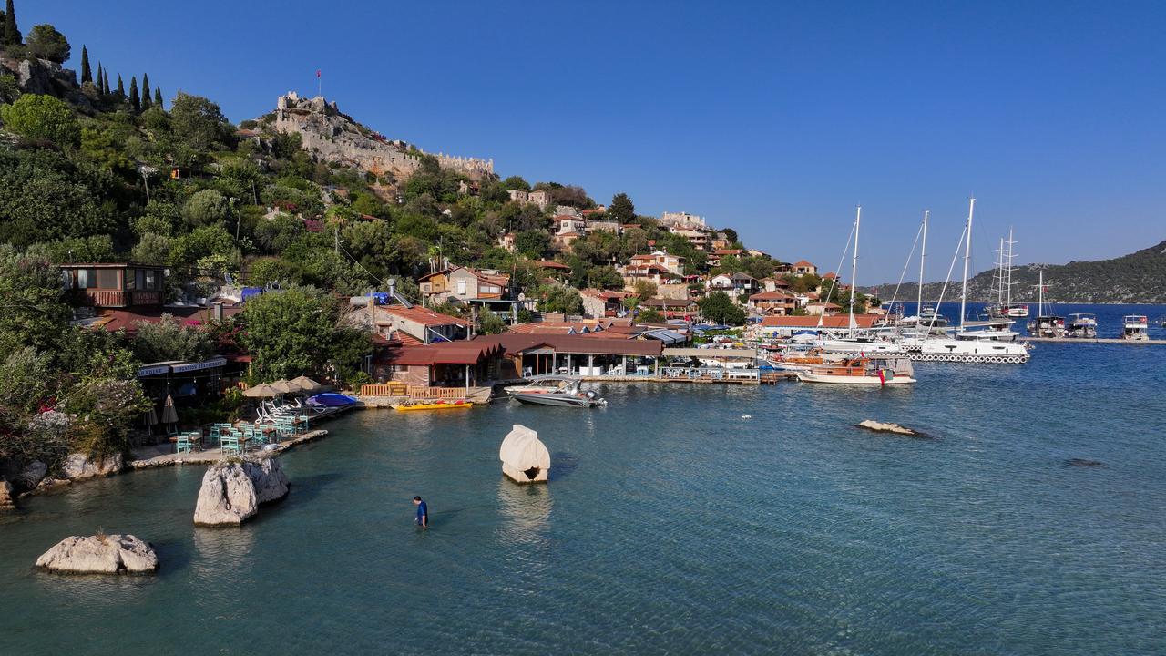 A general view of Kalekoy (ancient Simena) with its fortress, harbor, and Lycian sarcophagus standing in the shallow waters, Antalya, Türkiye, Sept. 21, 2025. (AA Photo)