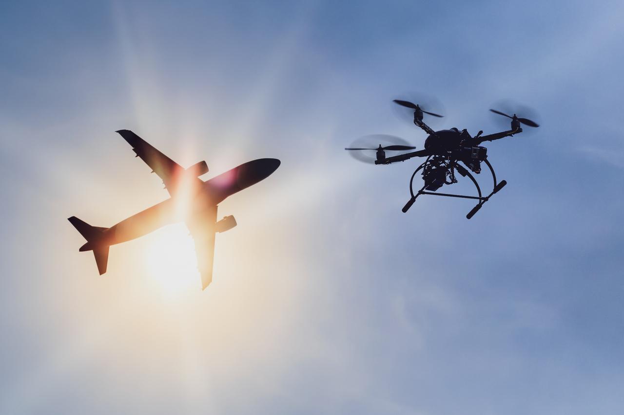 A drone flying near commercial airspace highlights growing concerns over aviation safety. (Adobe Stock Photo)