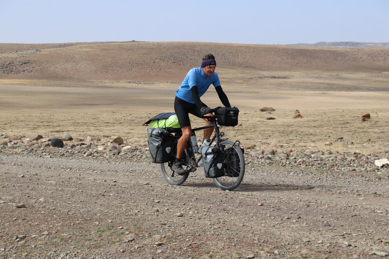 A French traveler cycles through Türkiye’s rugged eastern highlands during his cross-continental journey to explore cultures, Oct. 5, 2025. (AA Photo)