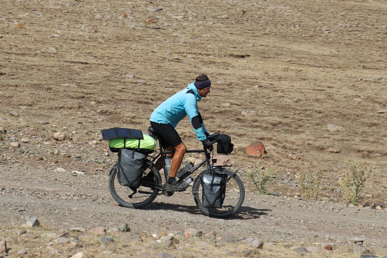 A French traveler cycles through Türkiye’s rugged eastern highlands during his cross-continental journey to explore cultures, Oct. 5, 2025. (AA Photo)