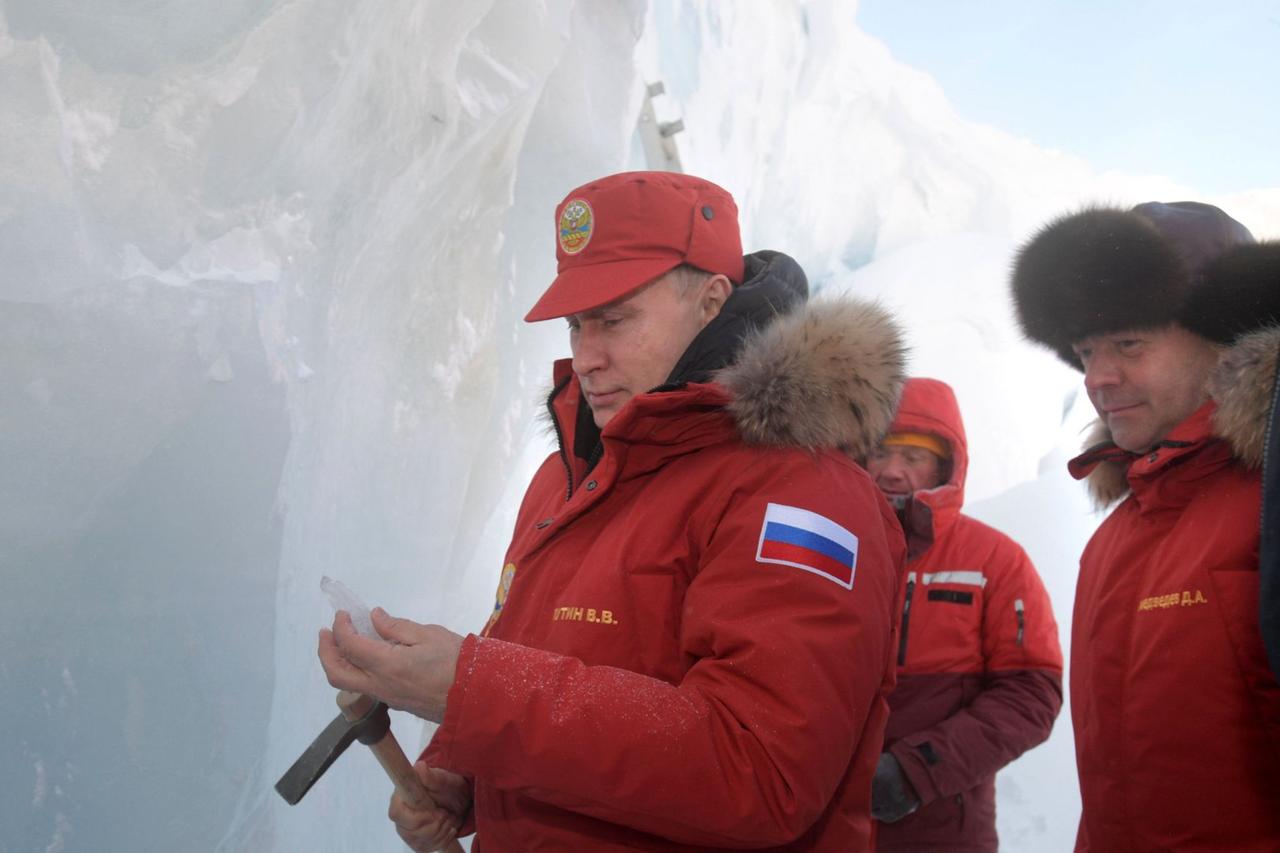 Russian President Vladimir Putin next to former Prime Minister Dmitry Medvedev, as they visit the remote Arctic islands of Franz Josef Land, March 29, 2017. (Photo via Sky News)
