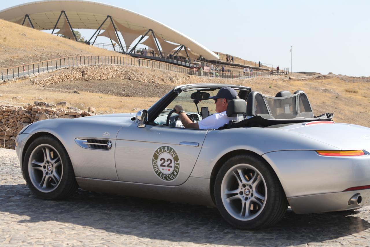 Classic car enthusiasts, who traveled from Belgium and toured two countries before arriving in Türkiye, visits Gobeklitepe, a UNESCO World Heritage site, in Sanliurfa, Türkiye, Oct. 6, 2025. (AA Photo)