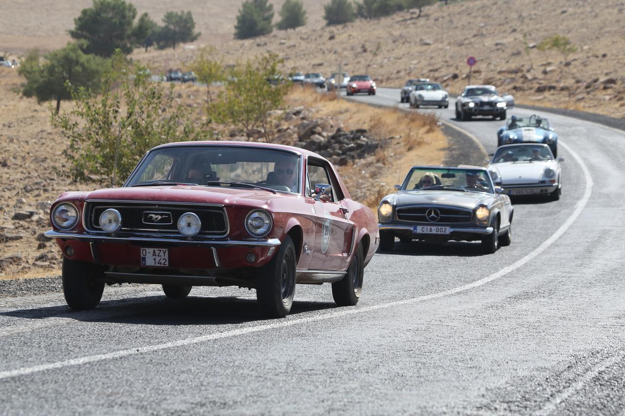 Classic car enthusiasts, who traveled from Belgium and toured two countries before arriving in Türkiye, visits Gobeklitepe, a UNESCO World Heritage site, in Sanliurfa, Türkiye, Oct. 6, 2025. (AA Photo)