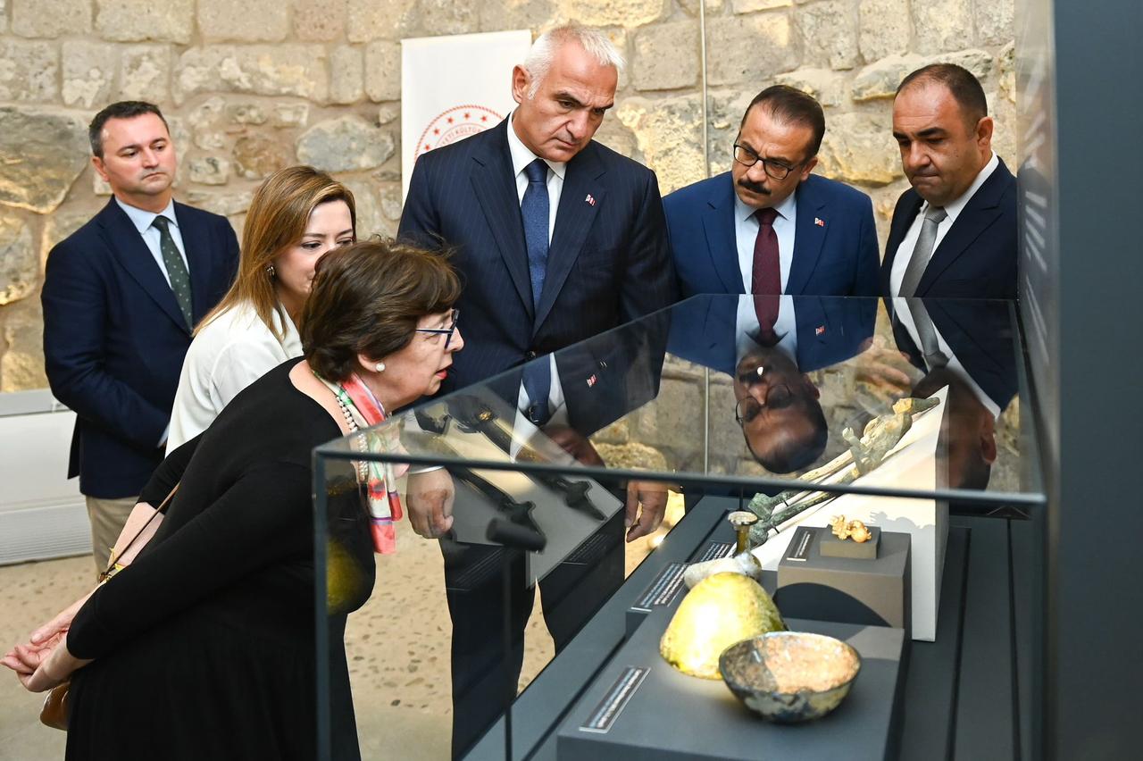 Culture and Tourism Minister Mehmet Nuri Ersoy views the repatriated artifacts during their presentation at Bodrum Castle, Türkiye, Oct. 7, 2025. (Photo via Ministry of Culture and Tourism)