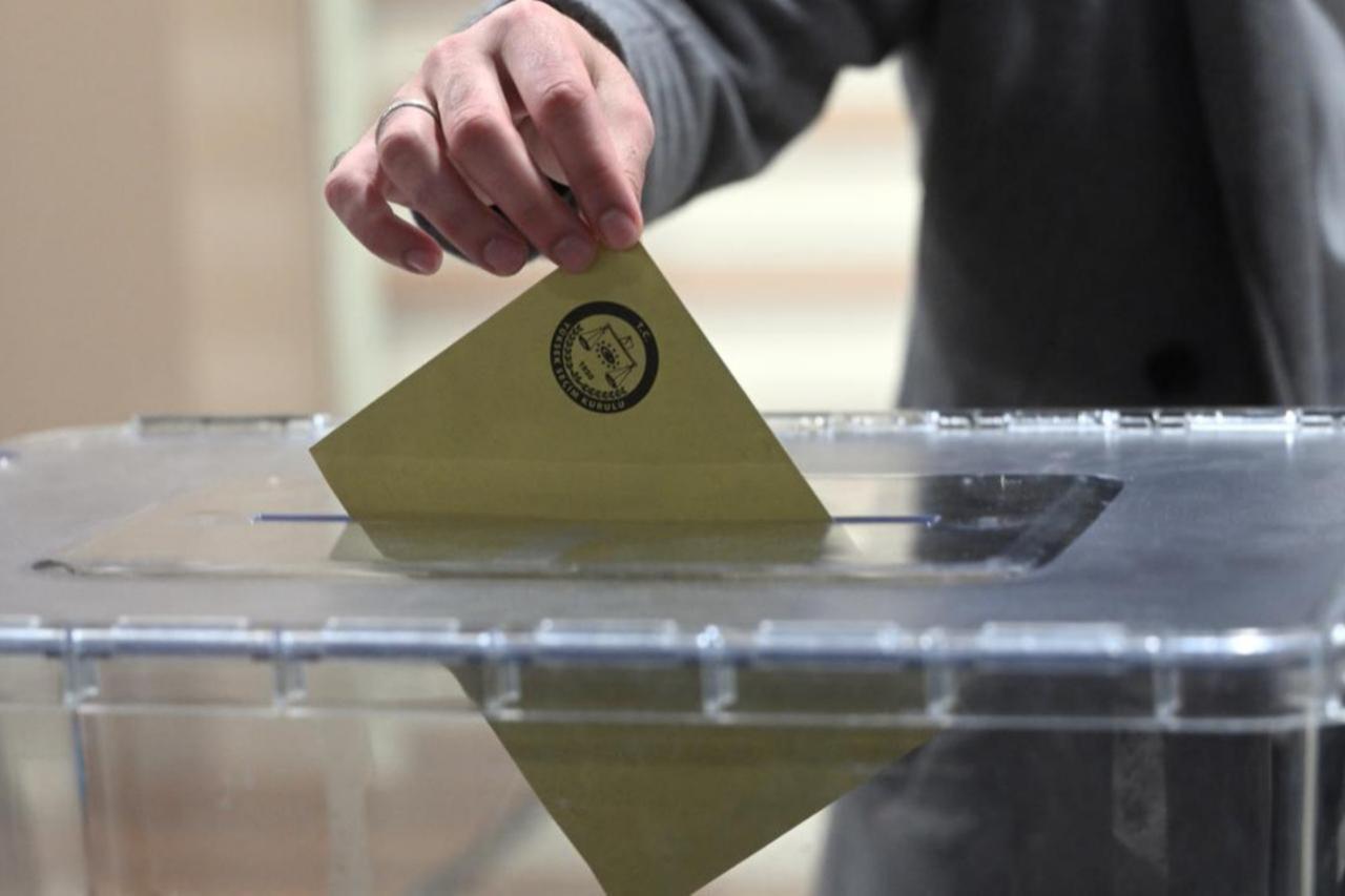 A voter casts a ballot into a sealed box during elections in Türkiye, accessed on Oct. 7, 2025. (AA Photo)