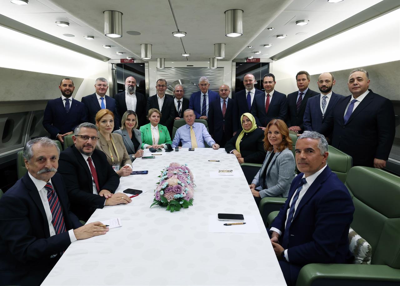 President Erdogan (C-R) speaks with journalists on the plane after attending the 12th Summit of the Organization of Turkic States (OTS) in Azerbaijan on Oct. 7, 2025. (Photo via Turkish Presidency/Murat Cetinmuhurdar)