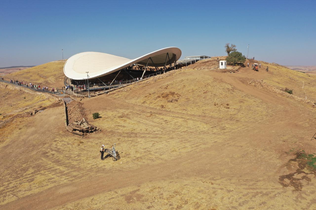 A researcher pushes a georadar cart during subsurface scanning near the monumental enclosures of Gobeklitepe in Sanliurfa, Türkiye, Oct. 8, 2025. (AA Photo)