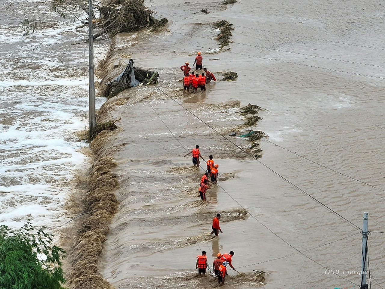 Rescuers navigate floodwaters to reach submerged homes in a village in Tuao, Cagayan province, following a river overflow caused by heavy rains from Super Typhoon Fung-wong. Cagayan, Philippines, November 10, 2025. (AFP PHOTO / CAGAYAN PROVINCIAL INFORMATION OFFICE (PIO)