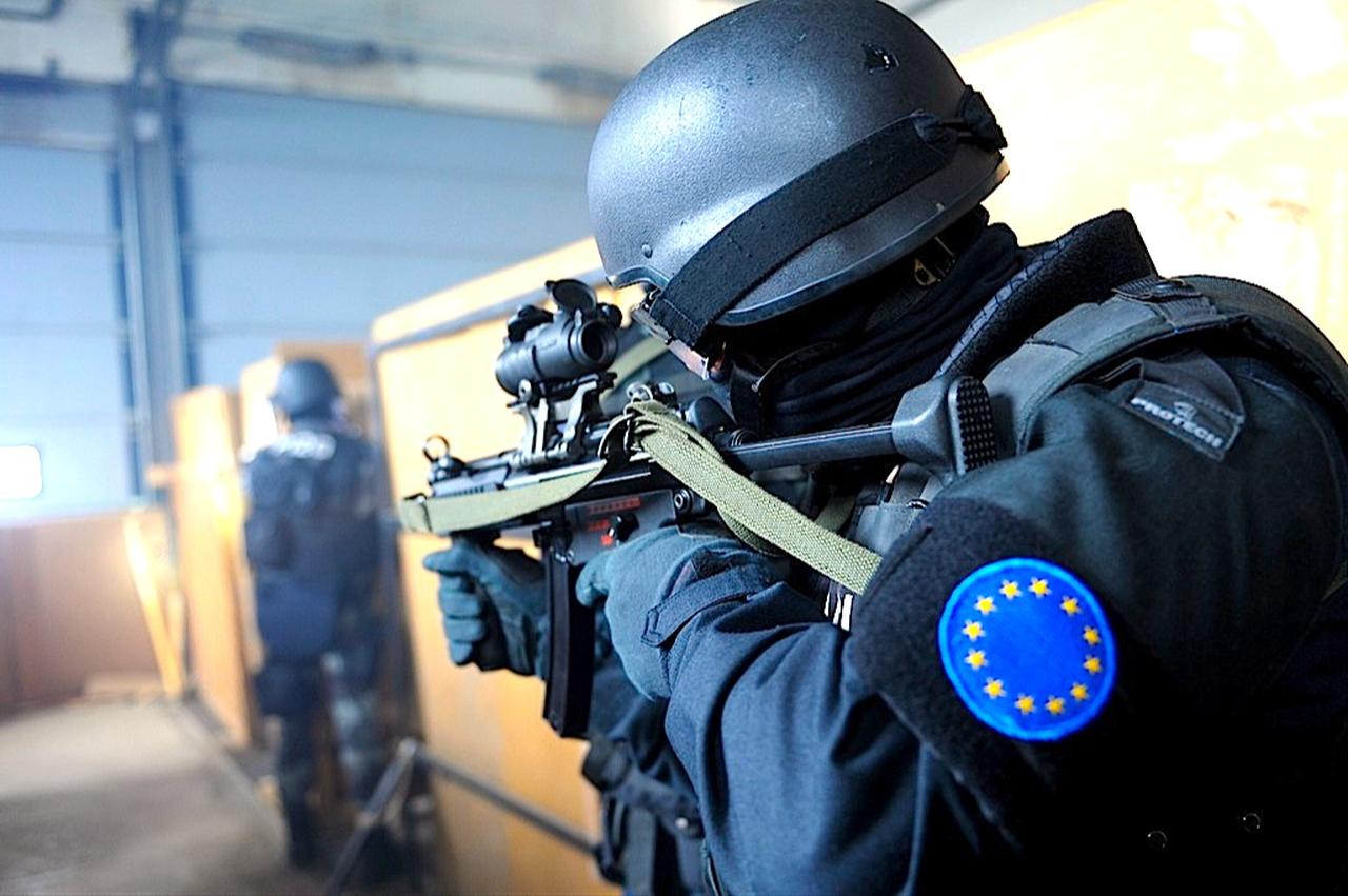 The image features a tactical police officer wearing gear that includes an arm patch of the European Union flag. (Photo via EU)