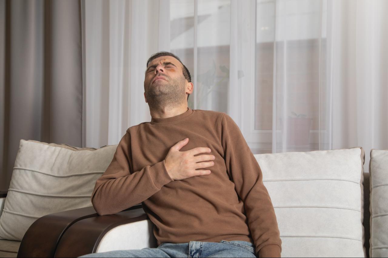A man having heart attack at home. (Adobe Stock Photo)