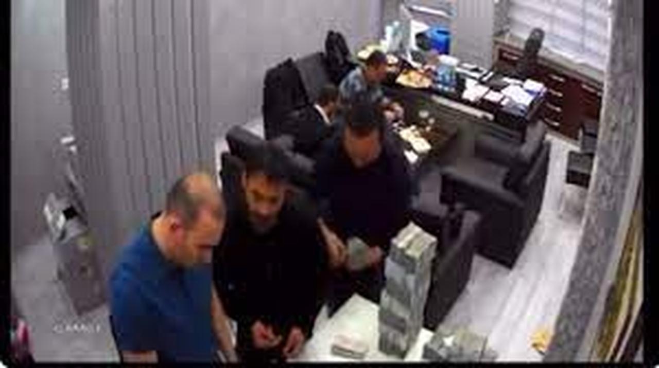 The image is a still frame from surveillance footage that is part of the "money-counting footage" case, a political controversy in Türkiye.