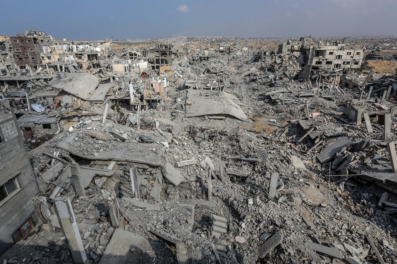 An aerial view of destruction as Palestinians inspect heavily damaged homes in the al-Ketiba area following the withdrawal of Israeli forces in Khan Yunis, Gaza, on Nov. 11, 2025. (AA Photo)