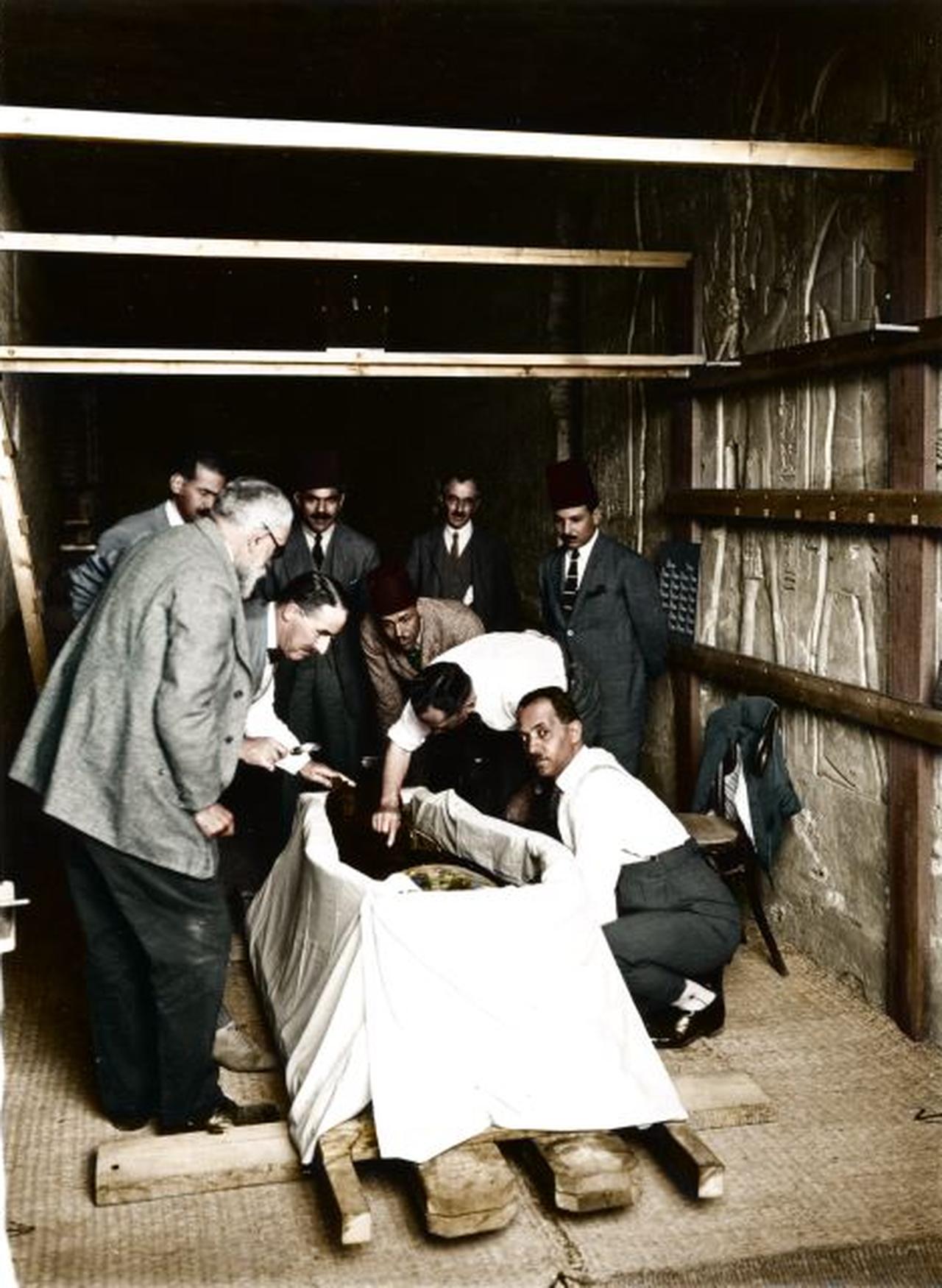 A colorised archival photograph captures the Tutankhamun Examination Committee watching as Douglas Derry makes the first incision in the pharaoh’s wrappings in 1925. (Photo by Harry Burton/Griffith Institute)