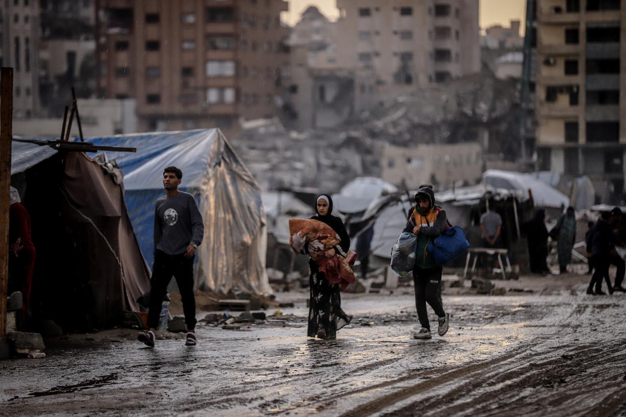 Palestinians, who lost their homes in Israeli attacks, struggle to live under harsh conditions in a tent camp as limited humanitarian aid packages reach the region despite 4 weeks since the announcement of the ceasefire in Gaza Strip on Nov. 14, 2025. (AA Photo)